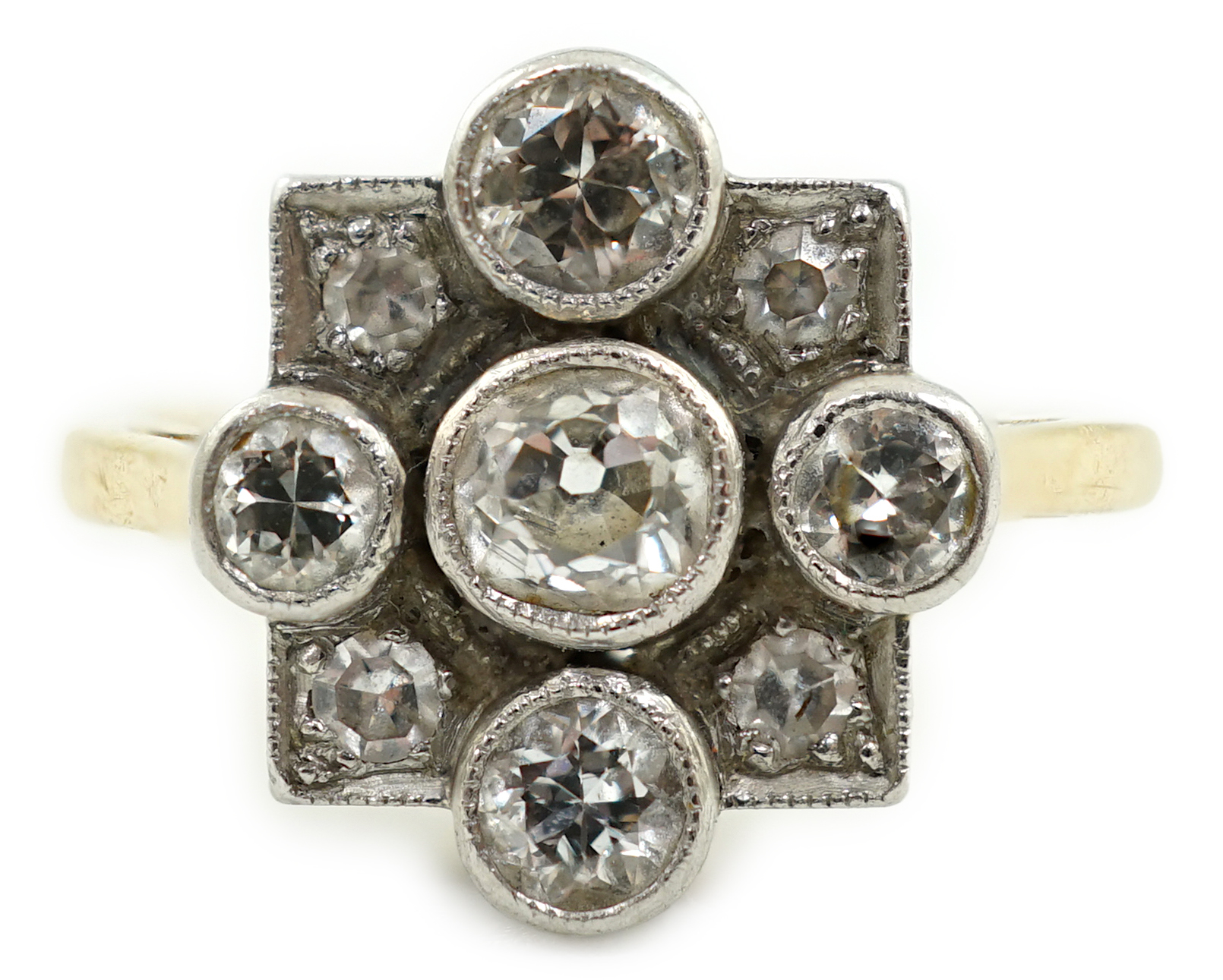 A 1920's/1930's 18ct gold, platinum and millegrain set nine stone diamond cluster ring